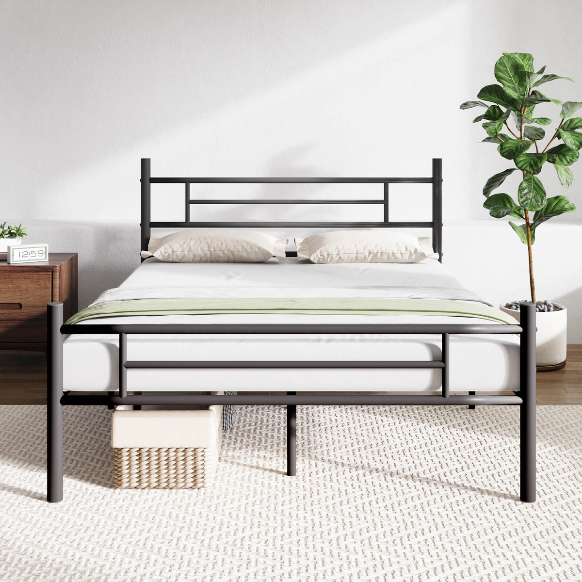 Wrought metal sleigh bed frame with geometric headboard, white mattress, and beige pillows on display.
