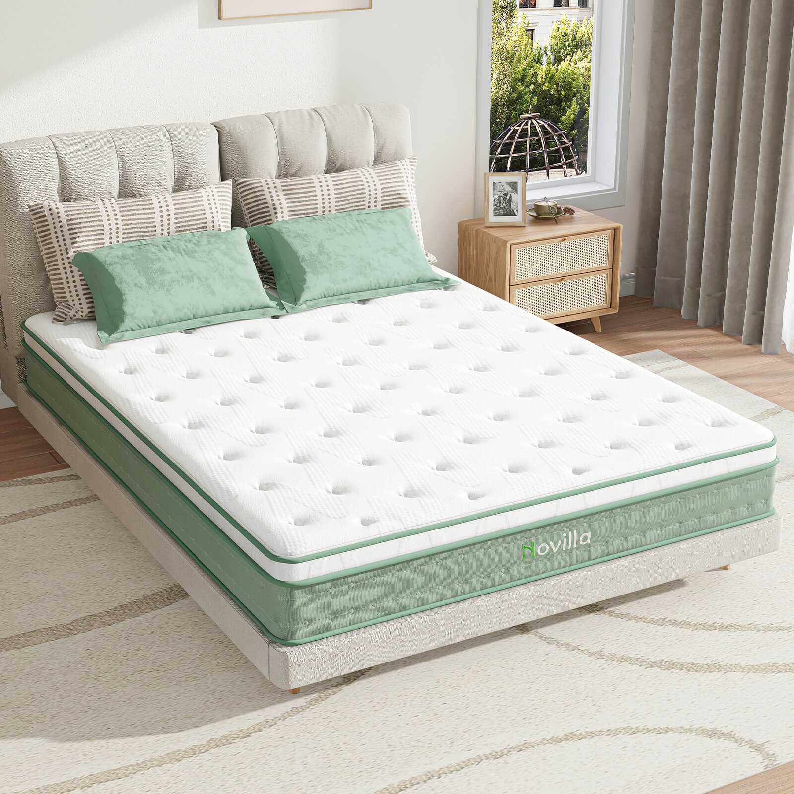 Oasis hybrid mattress with white quilted top and green side panel featuring Novilla logo on a bed.