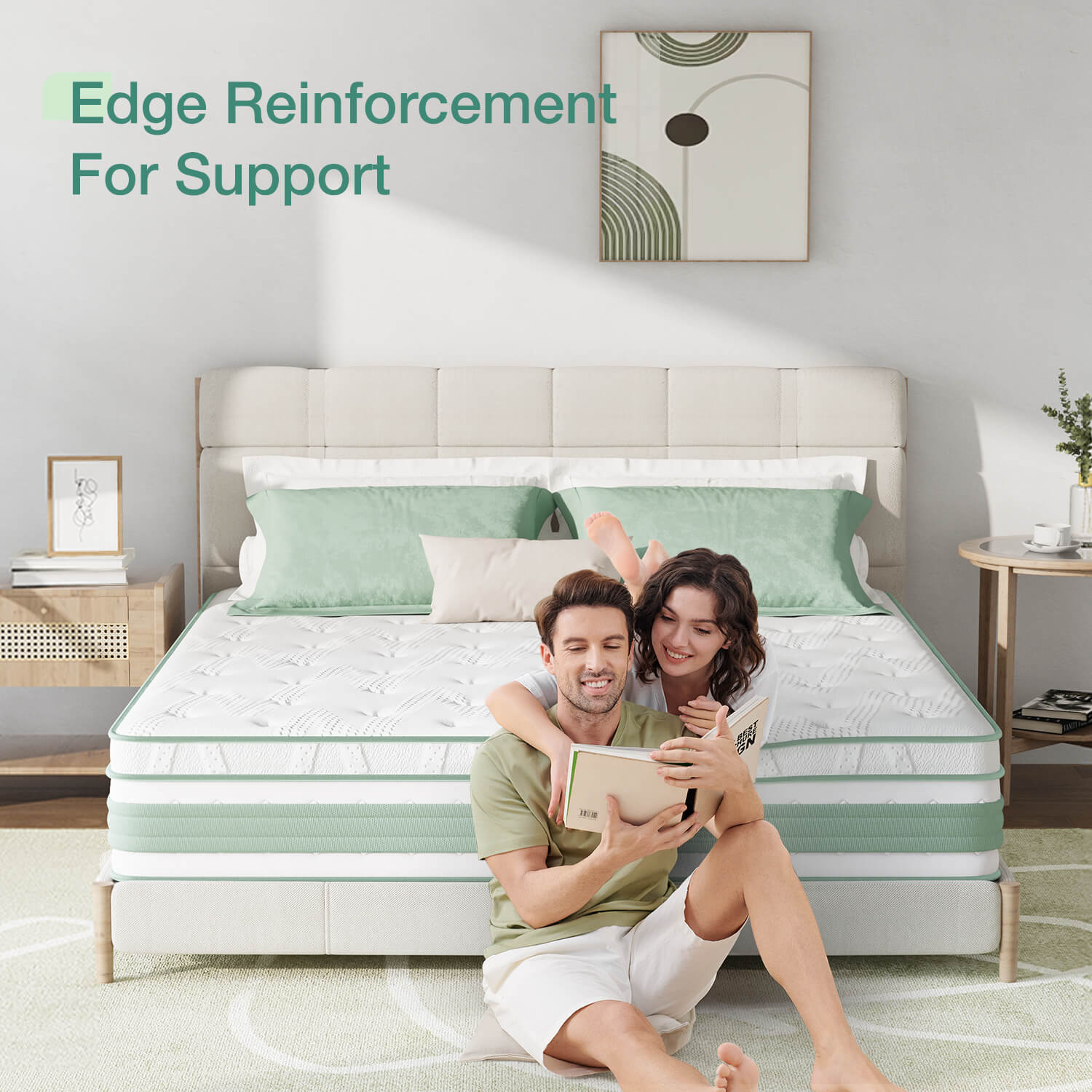 Buoyant Hybrid Mattress with edge reinforcement shown as a couple reads together on bed with mint green pillows.