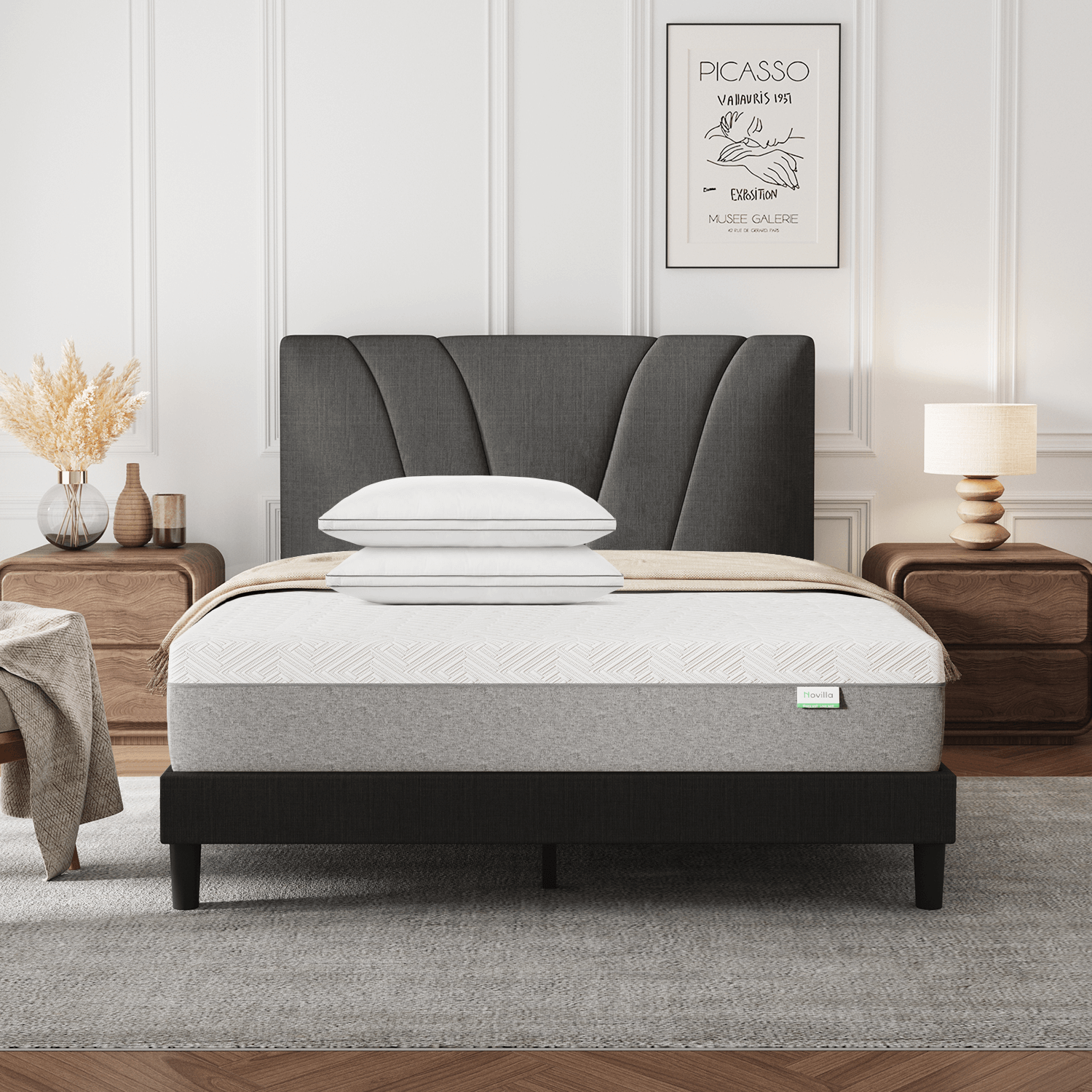 Bliss adjustable sleep bundle with mattress, pillows, and curved gray headboard on a black bed frame in a modern bedroom.