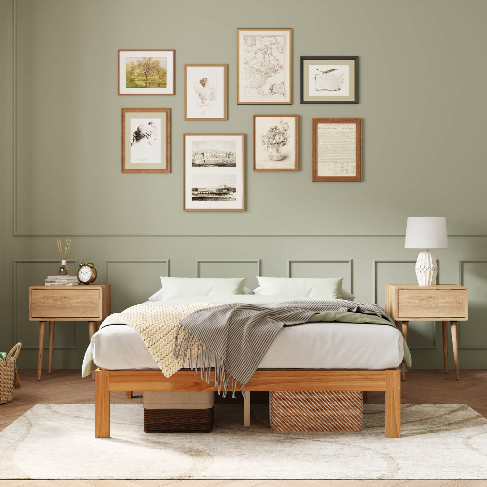 Classic wooden bed frame with white bedding in a bedroom with sage green walls and gallery wall.