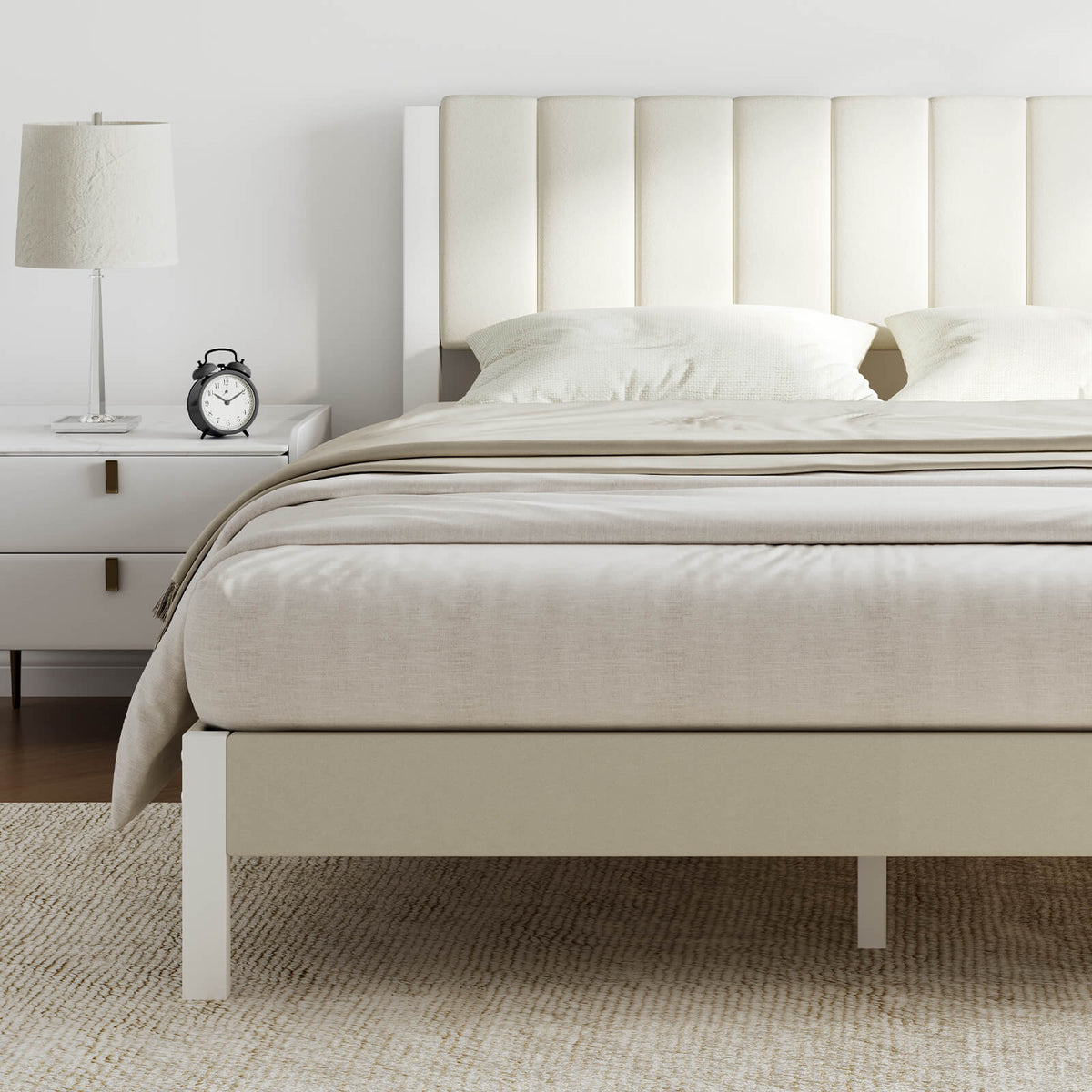 Cream velvet platform bed frame with tall channel-tufted headboard in a bright bedroom setting.